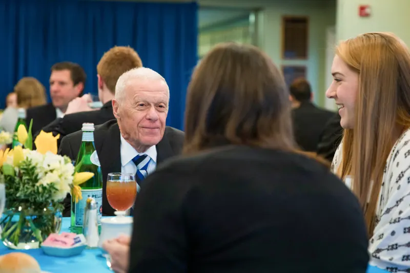 Armellino eating with students