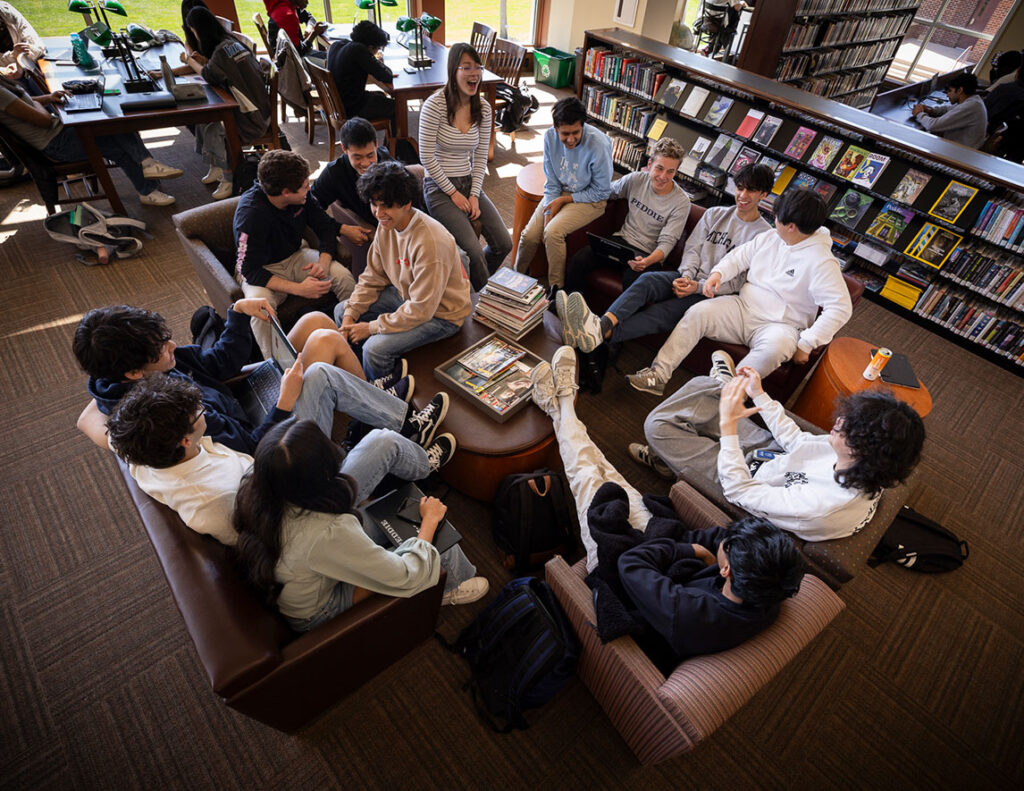 students sitting around in a circle in the library