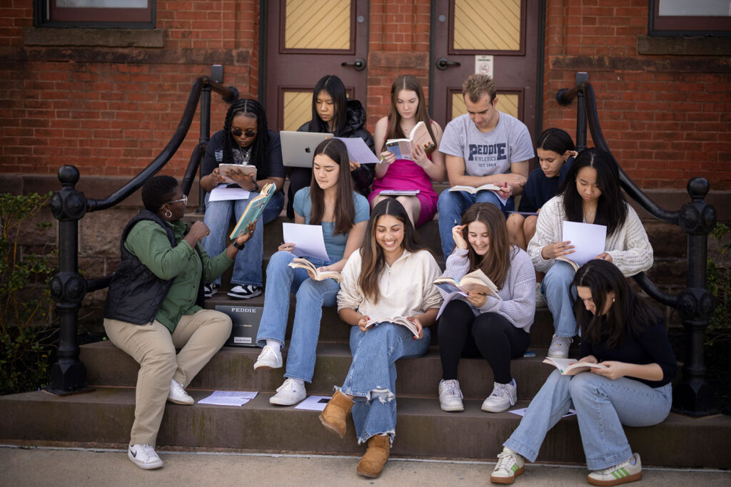 Jenate Brown teaching students in her English class outside on the steps of Longstreet Hall