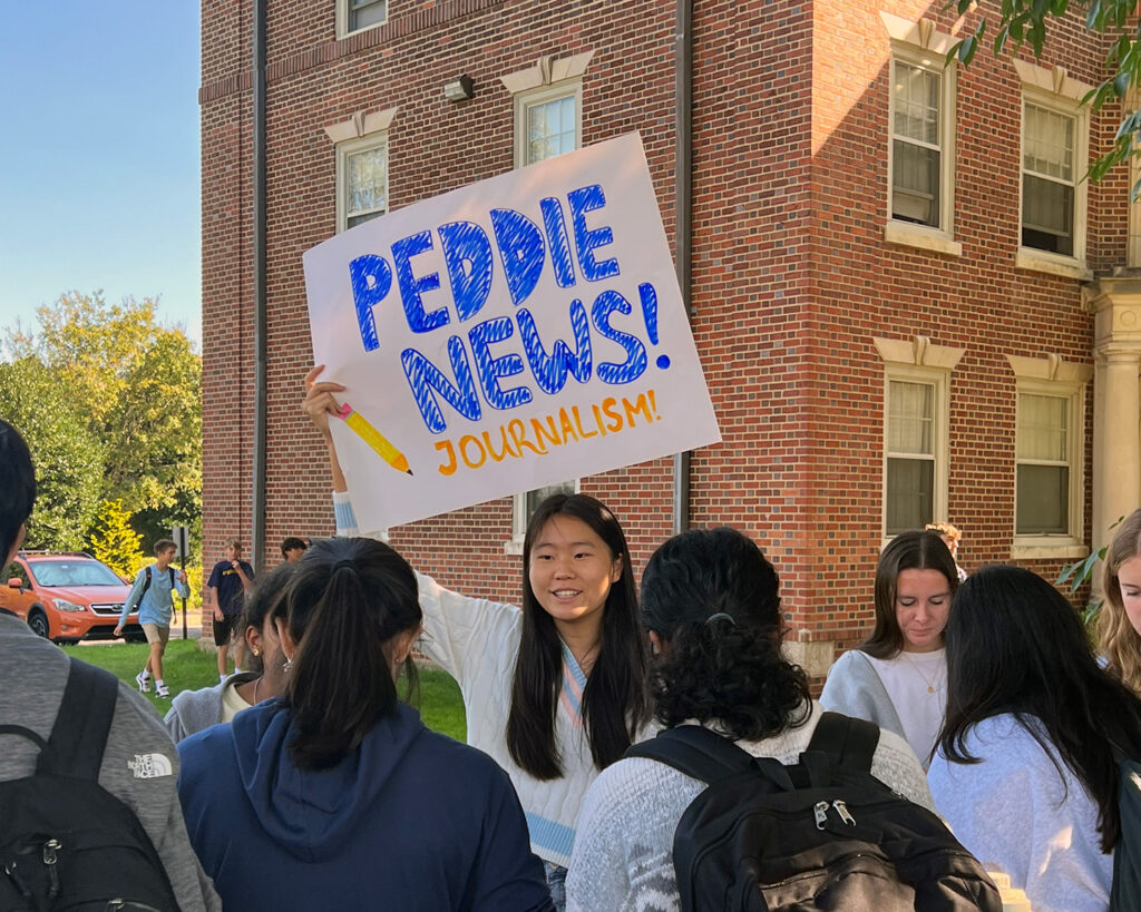 Student promoting Peddie News